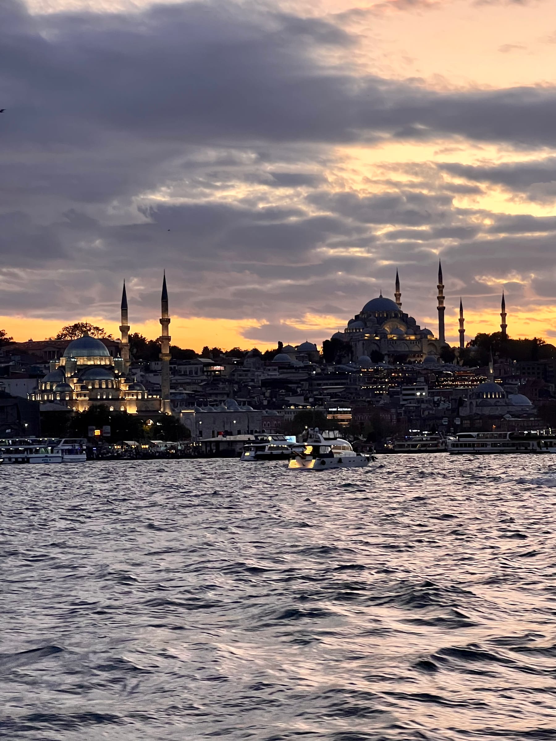 A private boat on the Bosphorus at sunset with the Istanbul skyline beyond